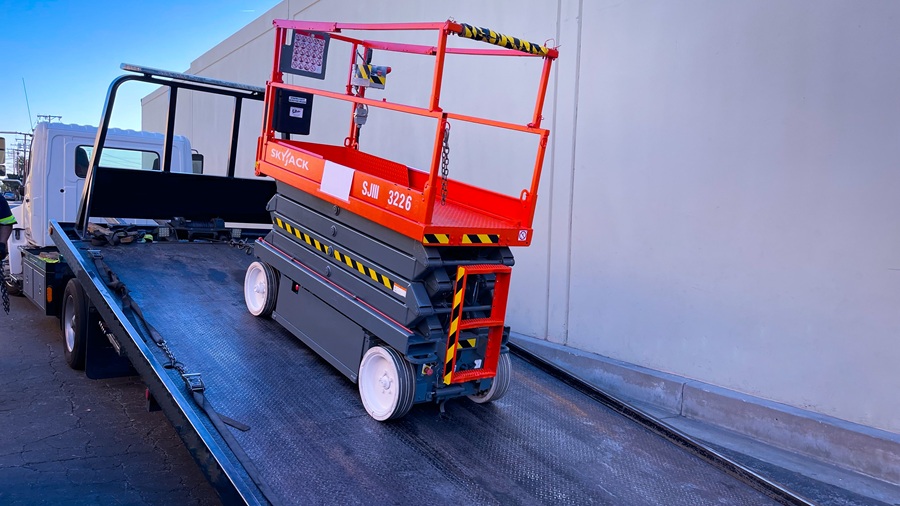 Skyjack scissor lift arriving on a Global Solutions LLC service truck